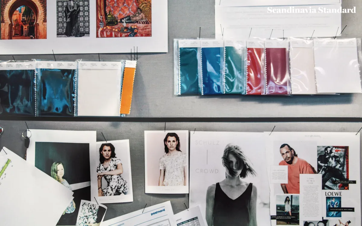 A desk with a lot of photos and papers on it.