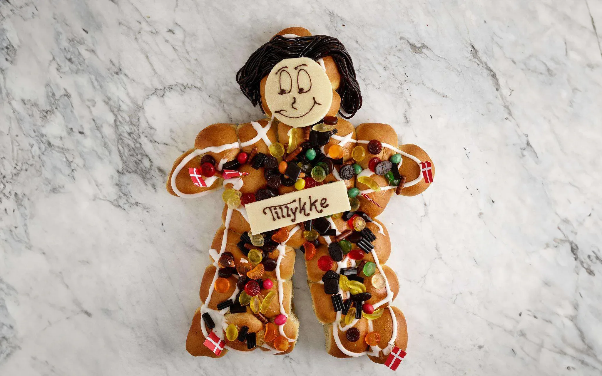 An image of a gingerbread man dressed up for Thanksgiving, incorporating Danish birthday traditions.