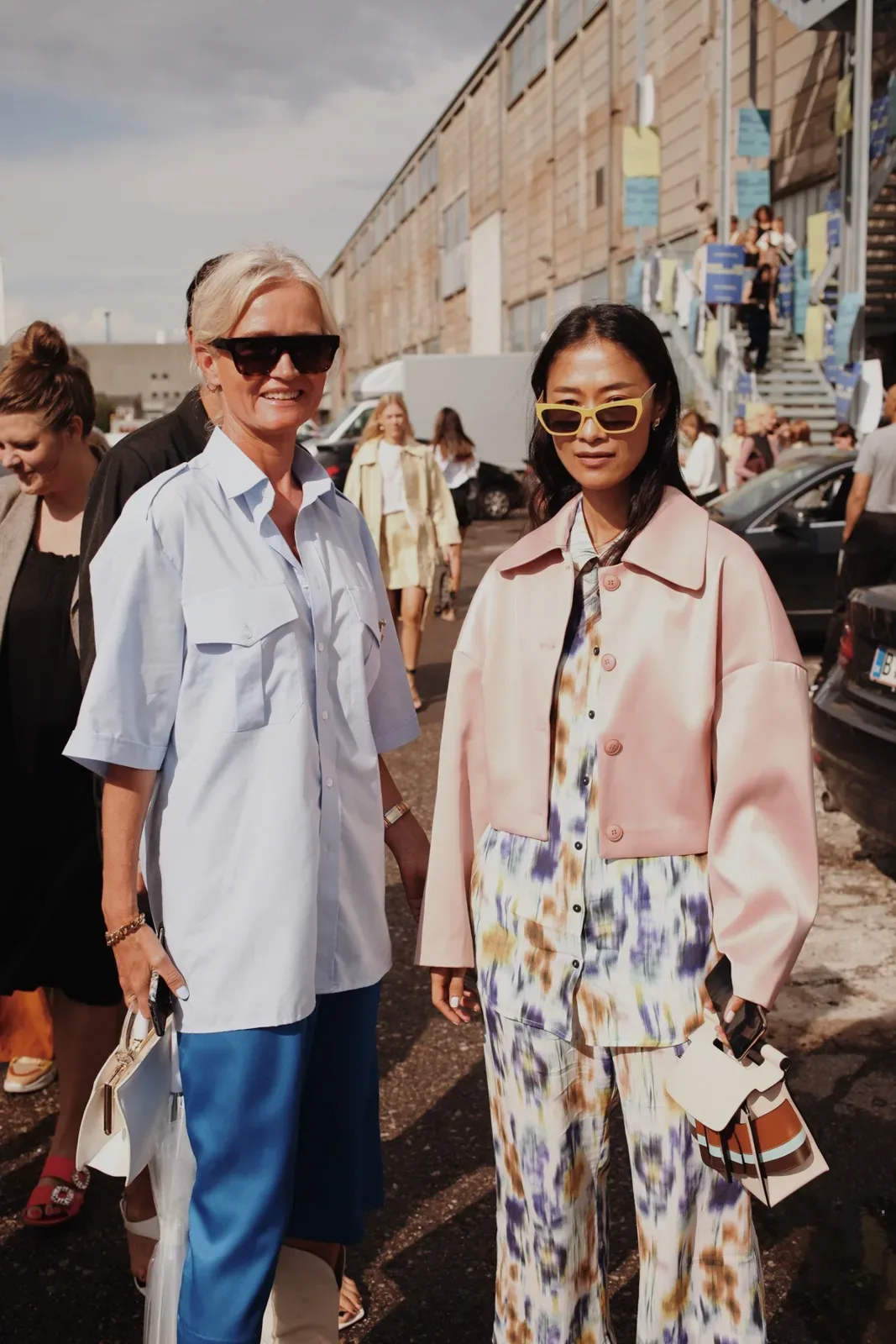 Two Scandinavian women standing next to each other on the street.
