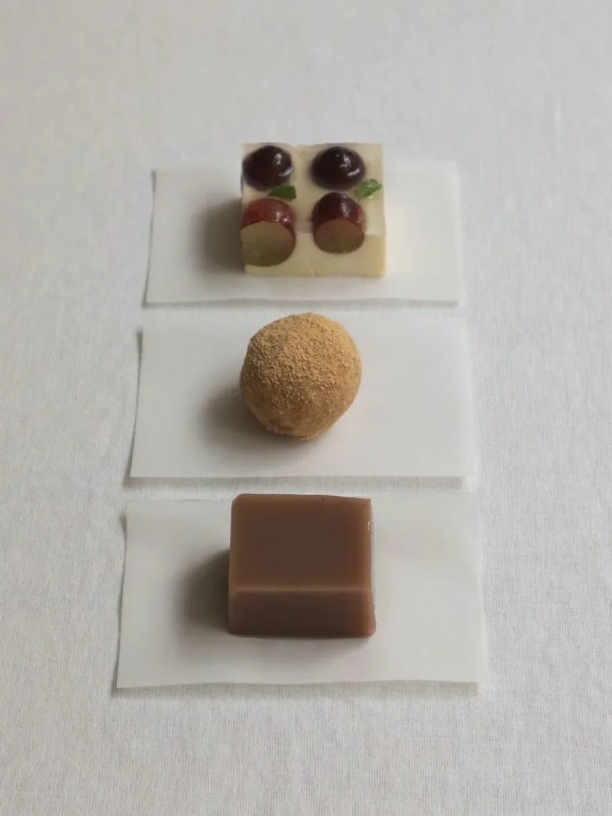 Three different types of chocolates on a white surface.
