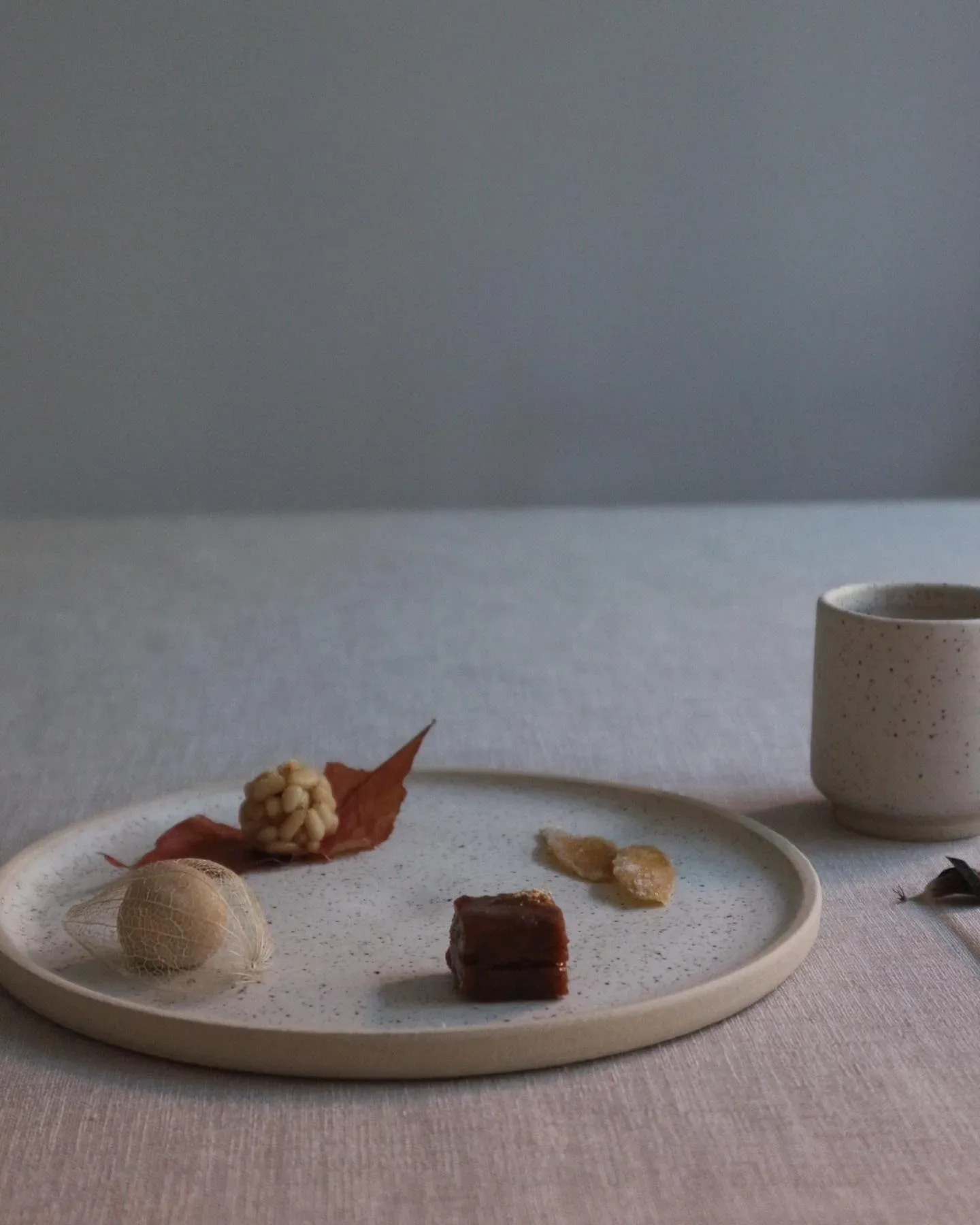 A plate with a cup of coffee and a dessert from Denmark on it.
